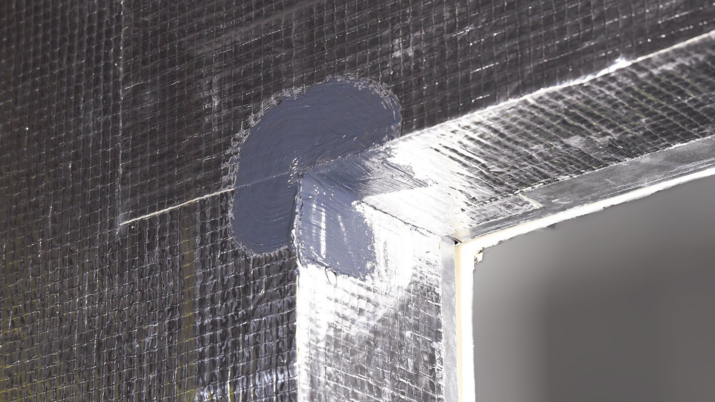 A corner of educational building with WALLcontrol reinforced aluminum flashing and STPE flashing from an AWB system.