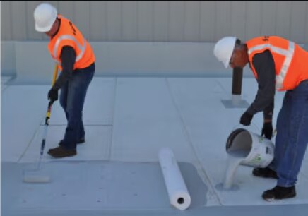 two siplast workers applying a parapro roof membrane with pro fleece Two Siplast workers applying a Parapro Roof Membrane with Pro Fleece